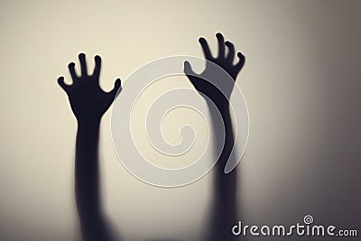 Silhouette of woman hands behind glass door. Concept of depression, fear, panic attacks Stock Photo