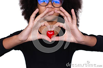 Dark-skinned curly girl holding a red heart Stock Photo