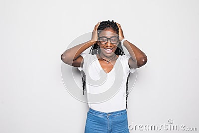 Dark-skinned young african woman in beige long sleeved t-shirt frowning, having painful expressions, suffering from bad severe Stock Photo