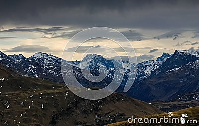 Dark storm clouds over snow spotted mountains. Allgau, Alps, Germany. Stock Photo
