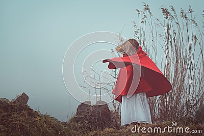 Dark and surreal portrait of a red hooded woman Stock Photo