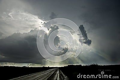 Dark thunder clouds and dramatic storms fill the sky over the sw Stock Photo