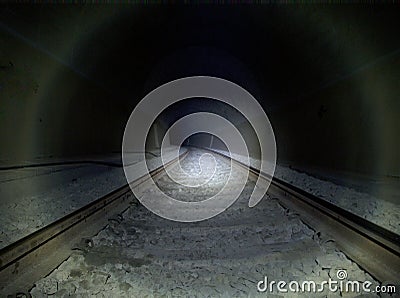 Dark tunnel railway with flash lamp light Stock Photo