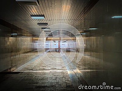 Dark urban underpass, long tunnel with marble walls Stock Photo