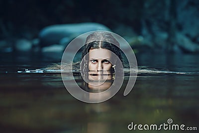 Dark water nymph with intense gaze Stock Photo