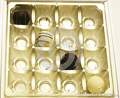 Dark and White Chocolates in an Almost Empty Box Stock Photo