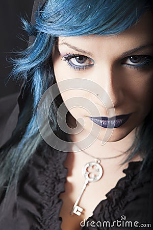 Dark woman with blue hair and lipstick. Key pendant. Dark girl Stock Photo