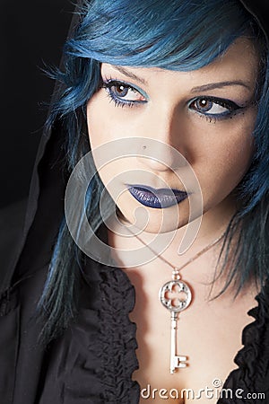 Dark woman with blue hair and lipstick. Key pendant. Dark girl Stock Photo