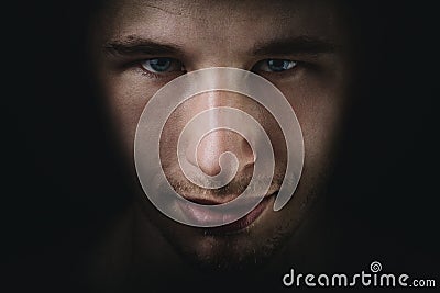 Dark young adult man portrait fade in black Stock Photo