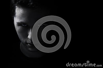 Dark young adult man portrait fade in black Stock Photo