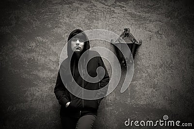 Dark young woman sad standing near urban wall black and white Stock Photo