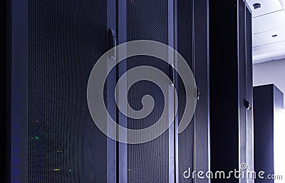 Darkened room with rows of modern server hardware Stock Photo