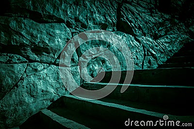 Darkness and horror, ghost house. Dark stone ruined old staircase from the basement with mystical shadows and strange light Stock Photo