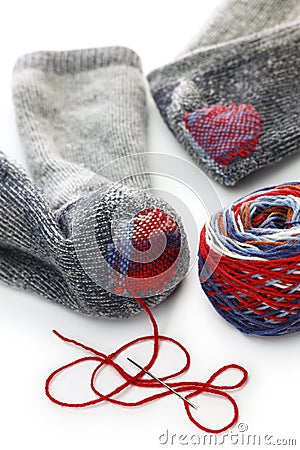 Darning socks, repairing holes in socks Stock Photo