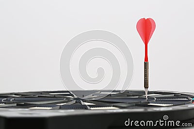 Dart arrow aimed at the dart game-board Stock Photo