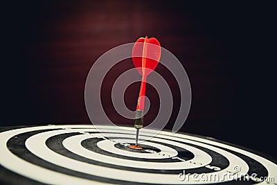 Dart hits center Bullseye is a target and goal of business, vintage style Stock Photo