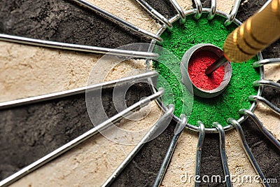 A dart hits the center of the darts board also known as Stock Photo