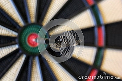 Dart hits target in the centre of dartboard Stock Photo