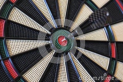 Dart hits target in the centre of dartboard Stock Photo