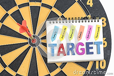 Dart target in bullseye with words target on the notebook with h Stock Photo