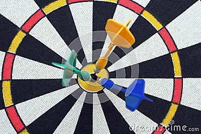 Dartboard with darts in aim Stock Photo