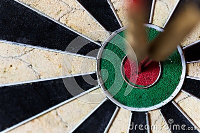 Dartboard with Steeldarts in bullseye Stock Photo
