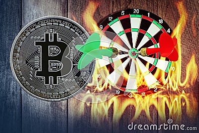 Darts arrow on dartboard with golden bitcoin wooden with flames and smoke dust Stock Photo