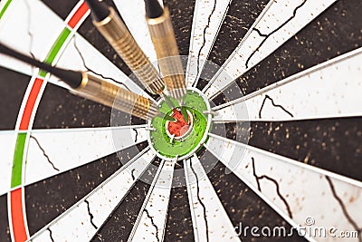 Darts arrows in the target center. Dart in bulls eye of dartboard Stock Photo