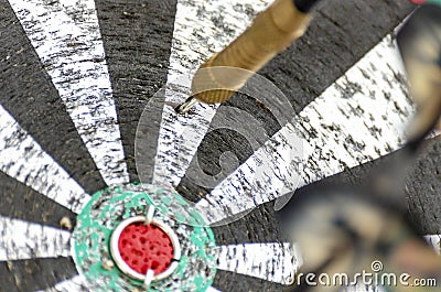 Darts Missing Bullseye on a Worn Out Dartboard. Proper Targeting, Losing Concept Stock Photo