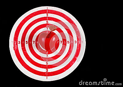 Darts target with heart on black Stock Photo