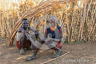 Dasanesh young mans resting in shadow of hut, Omorate, Omo Valley, Ethiopia people diversity Editorial Stock Photo