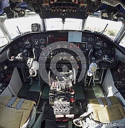 Dashboard, pilot seats, steering wheels in the cockpit of An-30, aerial cartography aircraft Editorial Stock Photo