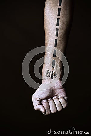 Dashed line and word life in a forearm Stock Photo