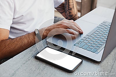 Data backup files to online cloud storage using wifi connection concept. Male hands using laptop and smartphone with blank screen Stock Photo