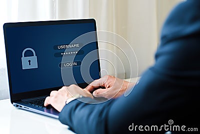 data protection and internet security concept. man works on a laptop with inscriptions on the screen login and password. Stock Photo