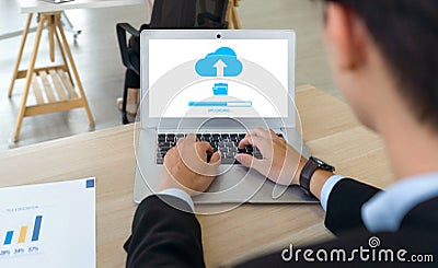 Data storage, networking and internet service concept. Back view of businessman using cloud drive technology upload save files to Stock Photo