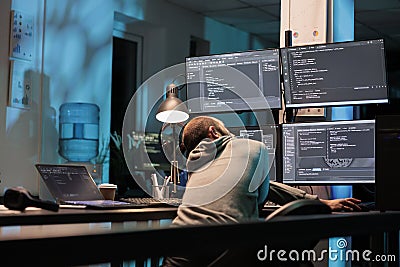 Database admin typing programming code on computer Stock Photo