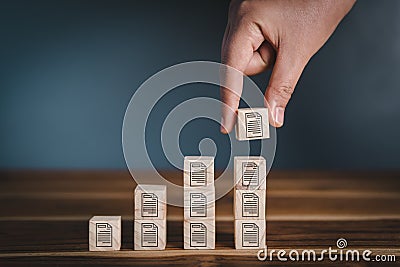Database Documentation Files Management Trend Concept, Hand is Putting Wooden Cube With File Icon Stacking Storage. Strategy Plan Stock Photo