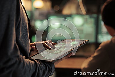 Database illegal access, hacker using spyware on digital tablet Stock Photo