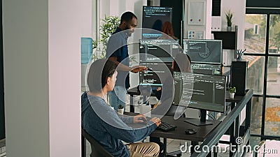 Database programer writing code on computer in software company office Stock Photo