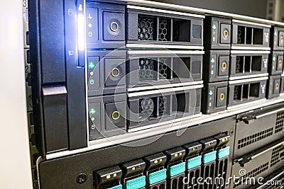 The database server is in the rack of the data center. Modern computer equipment is installed in the server room. Many hard drives Stock Photo