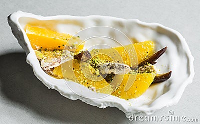 Date and orange salad with halva and pistachio yoghurt Stock Photo