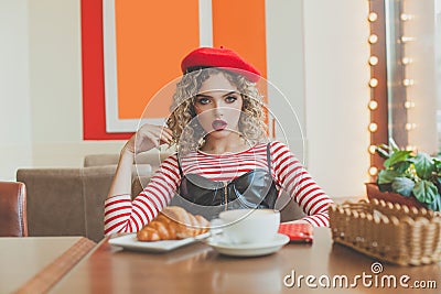 Dating. Woman french model in the cafeteria Stock Photo