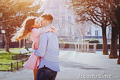 Dating, young happy caucasian couple kissing and laughing outside Stock Photo