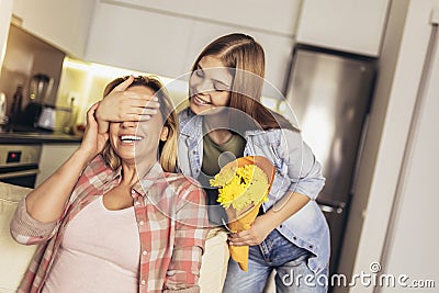Daughter congratulates mom and gives her flowers Stock Photo