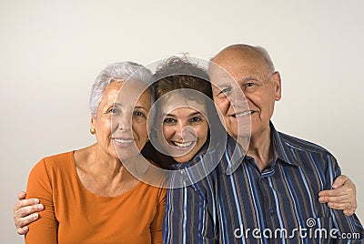 Daughter embracing her senior parents Stock Photo