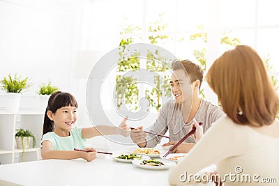 Daughter gives mother thumbs up for the delicious dinner Stock Photo