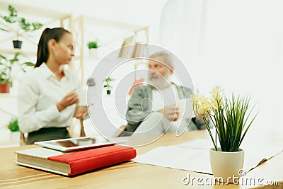A daughter or granddaughter spends time with the grandfather Stock Photo