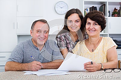 Daughter helping with documents to parents Stock Photo