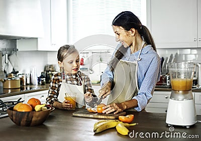 Daughter helping mom in preparing food Stock Photo